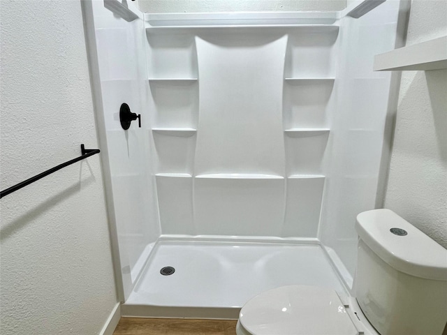5030 Glenvalley Dr, La Porte, TX 77571 - bathroom with a textured wall, a shower stall, and wood finished floors