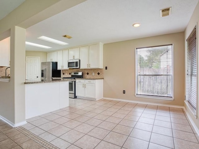 26610 W Surrey Park Ln W, Katy, TX 77494 - kitchen with stainless steel appliances, backsplash, light tile patterned floors, and healthy amount of natural light