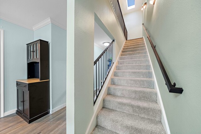 8416 Seawall Blvd Unit 5, Galveston, TX 77554 - staircase featuring ornamental molding, wood finished floors, and a skylight