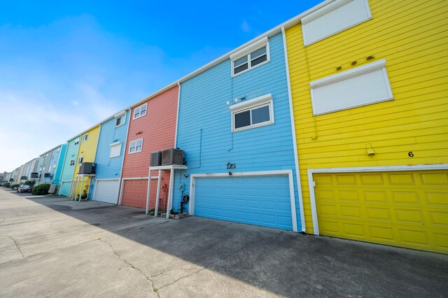 8416 Seawall Blvd Unit 5, Galveston, TX 77554 - view of building exterior featuring an attached garage and a residential view