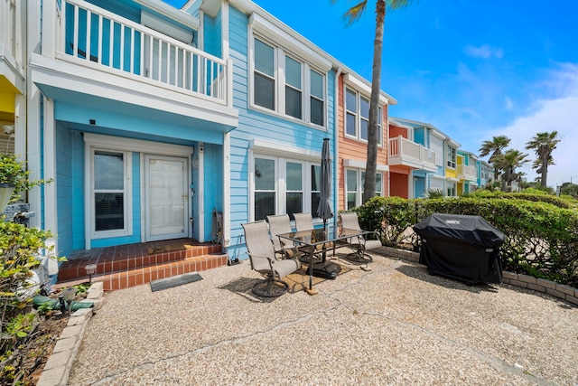 8416 Seawall Blvd Unit 5, Galveston, TX 77554 - patio / terrace with area for grilling, a patio, outdoor dining area, a residential view, and entry steps