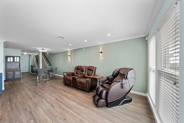 8416 Seawall Blvd Unit 5, Galveston, TX 77554 - living room featuring crown molding, wood finished floors, plenty of natural light, stairway, and recessed lighting