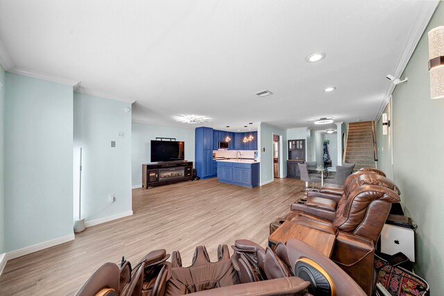 8416 Seawall Blvd Unit 5, Galveston, TX 77554 - living area with light wood-style flooring, recessed lighting, stairs, and ornamental molding