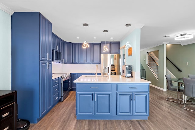 8416 Seawall Blvd Unit 5, Galveston, TX 77554 - kitchen with stainless steel appliances, blue cabinets, wood finished floors, crown molding, and light countertops