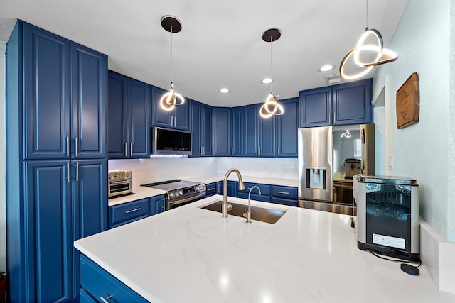 8416 Seawall Blvd Unit 5, Galveston, TX 77554 - kitchen featuring blue cabinetry, appliances with stainless steel finishes, hanging light fixtures, light stone countertops, and recessed lighting