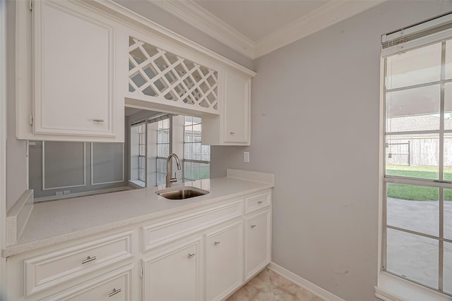 2112 Limrick Dr, Pearland, TX 77581 - kitchen featuring crown molding, light countertops, and white cabinetry