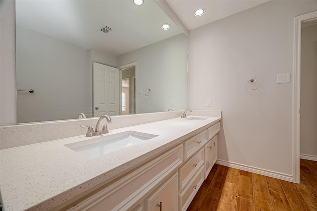2112 Limrick Dr, Pearland, TX 77581 - bathroom with double vanity, wood finished floors, and recessed lighting