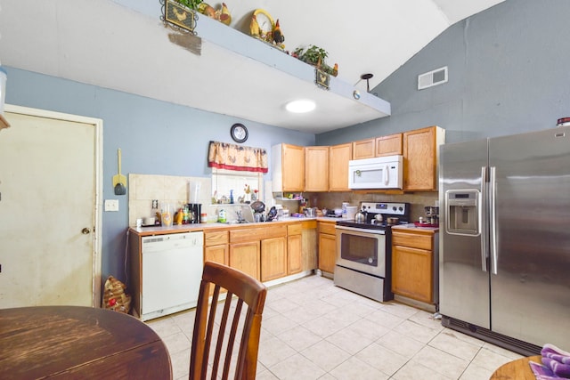 1732 Lynn Ln, Freeport, TX 77541 - kitchen with appliances with stainless steel finishes, light tile patterned floors, light countertops, high vaulted ceiling, and tasteful backsplash