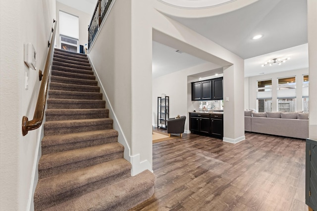 4110 Willow Wind Ct, Sugar Land, TX 77479 - stairs featuring wood finished floors and recessed lighting
