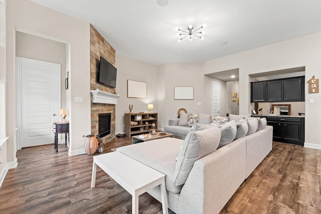 4110 Willow Wind Ct, Sugar Land, TX 77479 - living area featuring a fireplace, dark wood-style floors, and a chandelier