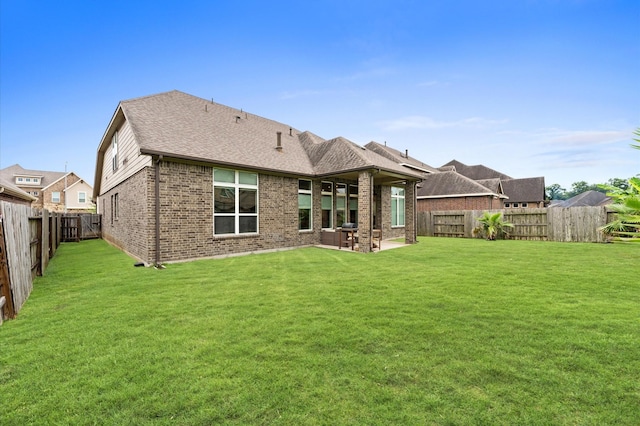 4110 Willow Wind Ct, Sugar Land, TX 77479 - back of property featuring brick siding, a fenced backyard, a patio, and roof with shingles