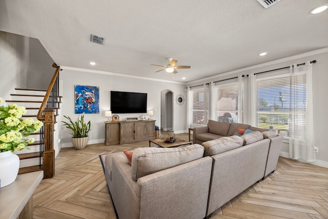 915 Bernard Meadows Dr, East Bernard, TX 77435 - living area with arched walkways, a textured ceiling, ceiling fan, stairway, and ornamental molding