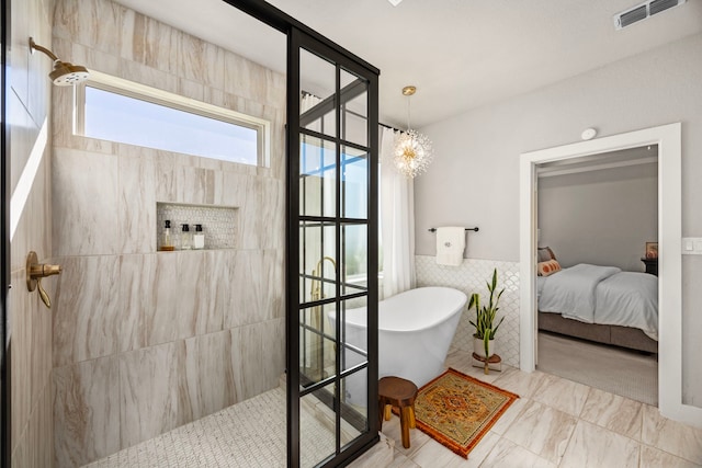 915 Bernard Meadows Dr, East Bernard, TX 77435 - ensuite bathroom with a soaking tub, walk in shower, tile walls, and a wainscoted wall