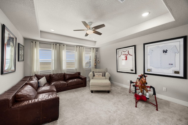 915 Bernard Meadows Dr, East Bernard, TX 77435 - carpeted living area featuring a tray ceiling, ceiling fan, and a textured ceiling