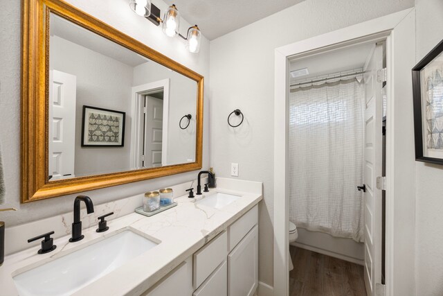 915 Bernard Meadows Dr, East Bernard, TX 77435 - bathroom featuring double vanity, wood finished floors, and shower / tub combo