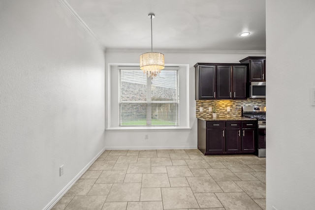 31767 Chapel Rock Ln, Spring, TX 77386 - kitchen featuring appliances with stainless steel finishes, a chandelier, ornamental molding, dark stone countertops, and dark brown cabinets
