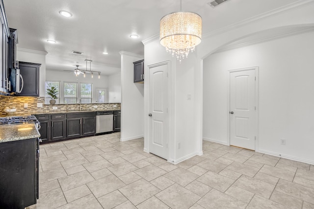 31767 Chapel Rock Ln, Spring, TX 77386 - kitchen featuring stainless steel appliances, crown molding, decorative backsplash, a ceiling fan, and light stone countertops