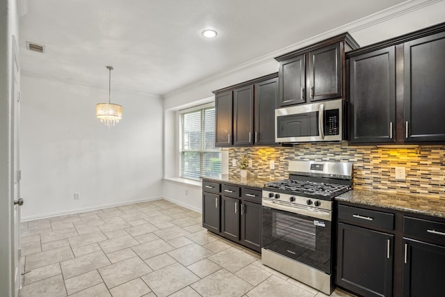 31767 Chapel Rock Ln, Spring, TX 77386 - kitchen with appliances with stainless steel finishes, decorative backsplash, dark stone counters, ornamental molding, and recessed lighting