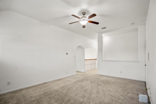 31767 Chapel Rock Ln, Spring, TX 77386 - empty room featuring ceiling fan, carpet, arched walkways, and lofted ceiling
