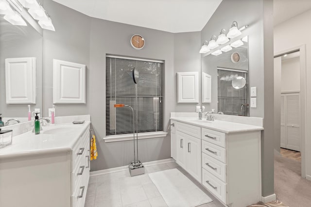 111 Mesa Ct, Conroe, TX 77304 - bathroom featuring two vanities and baseboards