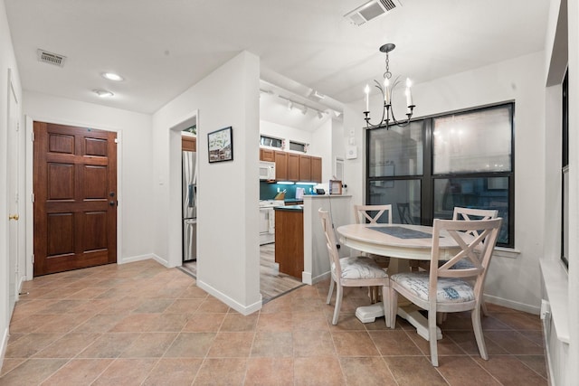 111 Mesa Ct, Conroe, TX 77304 - dining area with a chandelier and baseboards