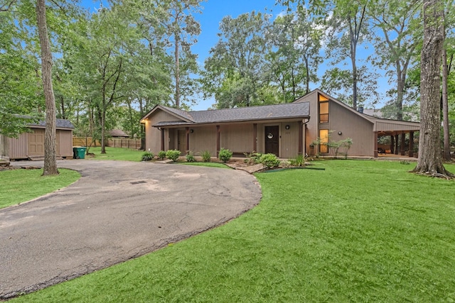 111 Mesa Ct, Conroe, TX 77304 - mid-century home featuring asphalt driveway and a storage shed