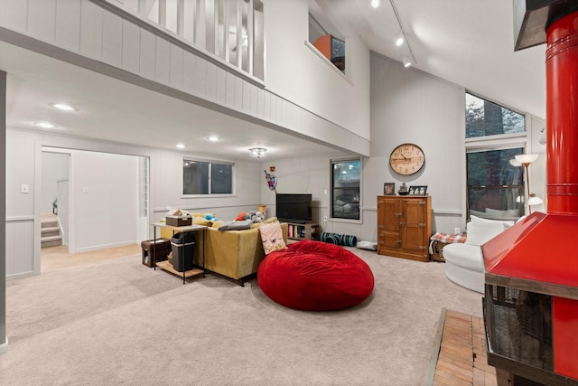 111 Mesa Ct, Conroe, TX 77304 - carpeted living area featuring a high ceiling, stairway, recessed lighting, and track lighting