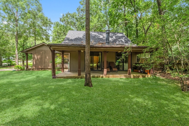 111 Mesa Ct, Conroe, TX 77304 - back of property with a patio area, a yard, and a shingled roof