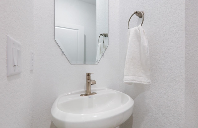 16031 Tangled Vine Ln, Conroe, TX 77378 - bathroom featuring a sink and a textured wall