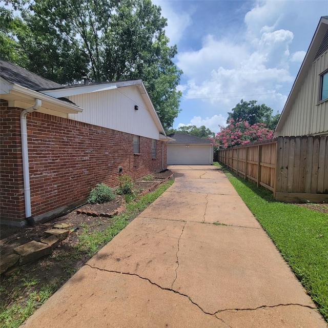 5227 Imogene St, Houston, TX 77096 - view of side of home featuring brick siding and a detached garage