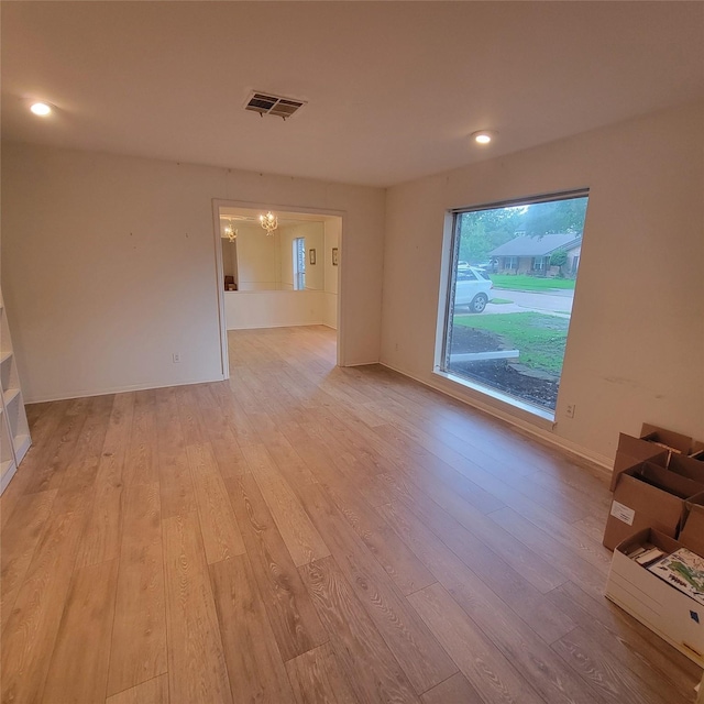 5227 Imogene St, Houston, TX 77096 - empty room featuring light wood-style flooring, a chandelier, and recessed lighting
