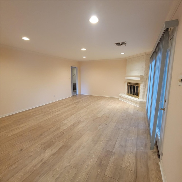 5227 Imogene St, Houston, TX 77096 - unfurnished living room featuring a fireplace, light wood-type flooring, and recessed lighting