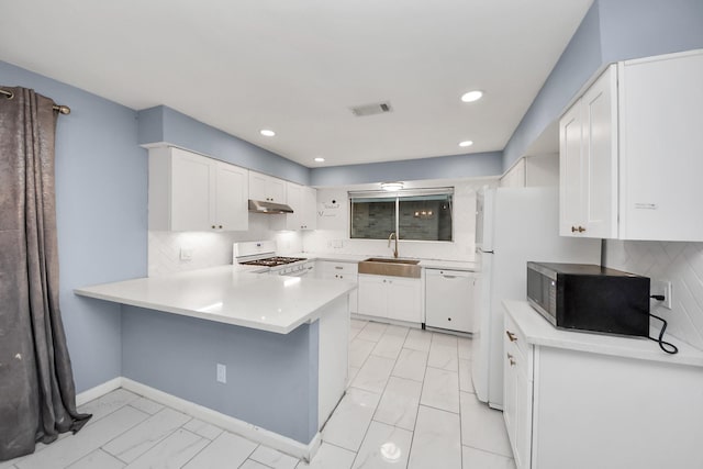 10731 Forest Leaf Dr, Sugar Land, TX 77498 - kitchen featuring white appliances, under cabinet range hood, light marble finish flooring, a peninsula, and white cabinets