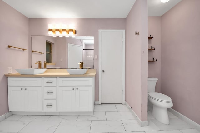 10731 Forest Leaf Dr, Sugar Land, TX 77498 - bathroom featuring double vanity and marble look tile flooring