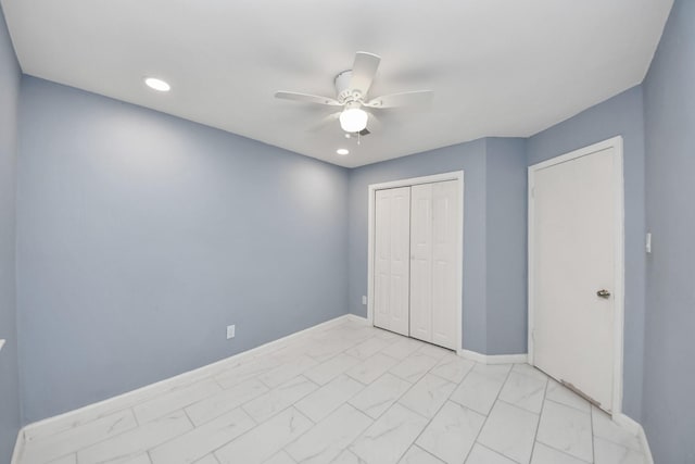 10731 Forest Leaf Dr, Sugar Land, TX 77498 - unfurnished bedroom featuring light marble finish flooring, a closet, a ceiling fan, and recessed lighting