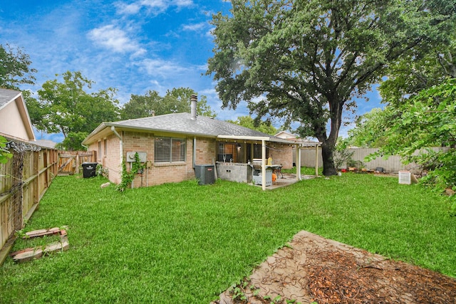 10731 Forest Leaf Dr, Sugar Land, TX 77498 - back of house featuring brick siding, a patio, a fenced backyard, and roof with shingles