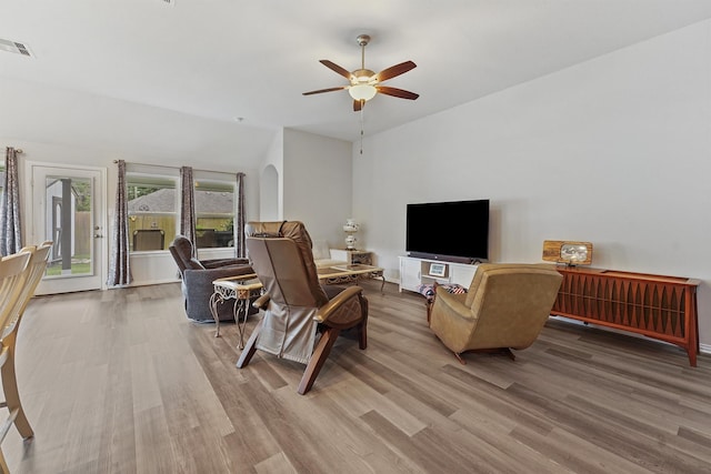 1203 Casal Springs Ct, Crosby, TX 77532 - living area featuring wood finished floors, lofted ceiling, ceiling fan, and arched walkways