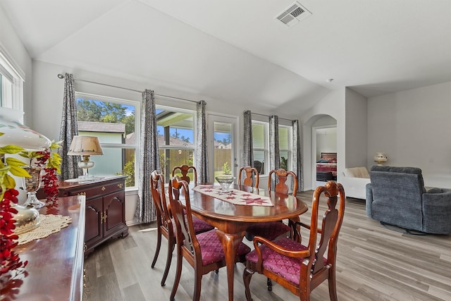1203 Casal Springs Ct, Crosby, TX 77532 - dining room with lofted ceiling, light wood finished floors, and arched walkways