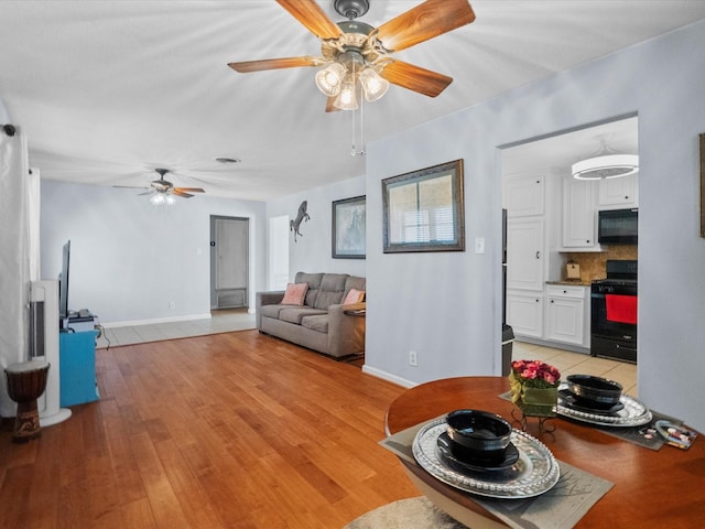 1901 49th St, Galveston, TX 77551 - living area featuring a ceiling fan and light wood-style flooring