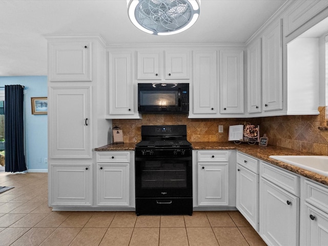 1901 49th St, Galveston, TX 77551 - kitchen with black appliances, light tile patterned floors, and white cabinets