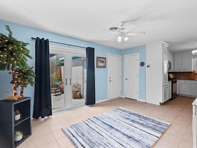 1901 49th St, Galveston, TX 77551 - entrance foyer featuring french doors, light tile patterned flooring, and a ceiling fan