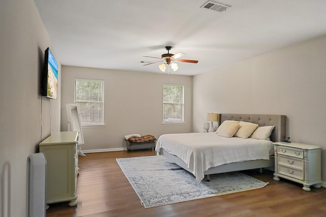 27535 Golf View Ln, Huffman, TX 77336 - bedroom with multiple windows, dark wood-type flooring, and ceiling fan