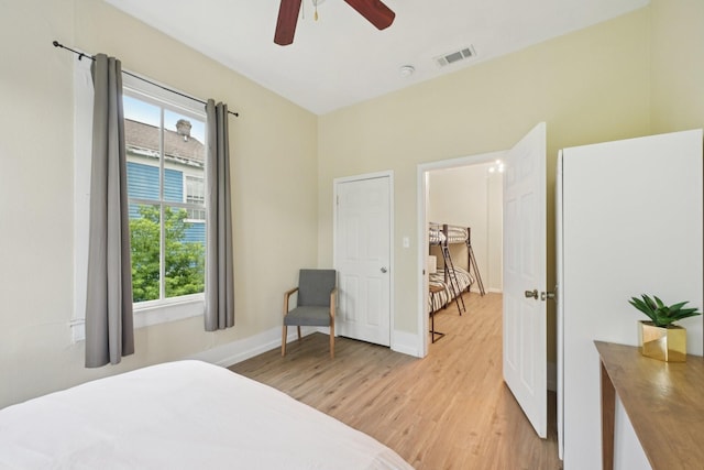 1913 Ursuline St, Galveston, TX 77550 - bedroom featuring light wood-type flooring, multiple windows, and a ceiling fan