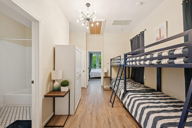 1913 Ursuline St, Galveston, TX 77550 - bedroom featuring attic access, wood finished floors, and a chandelier
