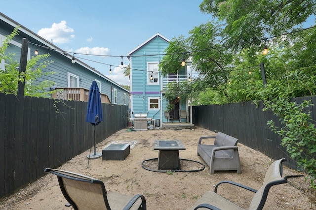 1913 Ursuline St, Galveston, TX 77550 - back of house with an outdoor fire pit and a fenced backyard