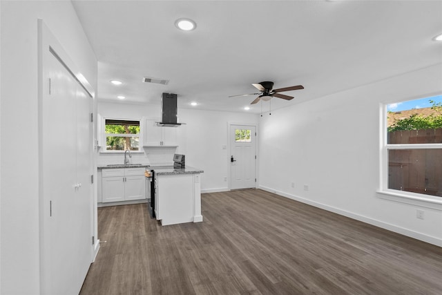 7613 Shotwell St, Houston, TX 77016 - kitchen with exhaust hood, white cabinetry, dark wood-style flooring, a ceiling fan, and recessed lighting