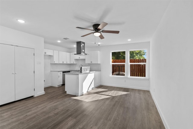7613 Shotwell St, Houston, TX 77016 - kitchen featuring extractor fan, white cabinets, a ceiling fan, dark wood finished floors, and a peninsula