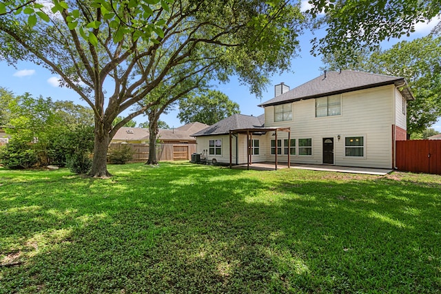 25807 Oakridge Forest Ln, Spring, TX 77386 - back of property with a fenced backyard, a chimney, and a patio area