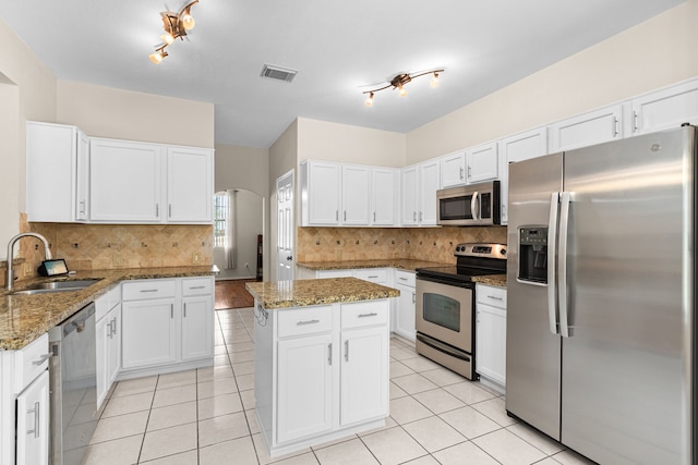 25807 Oakridge Forest Ln, Spring, TX 77386 - kitchen with stainless steel appliances, white cabinets, and light tile patterned floors