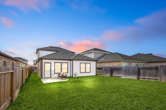 23242 Spring Genesis Ln, Katy, TX 77493 - back of house at dusk with a patio area and a fenced backyard